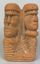 A TERRACOTTA RED STONE ANCESTRAL PLAQUE DEPICTING MALE AND FEMALE CARVED HEADS Possibly ancient,