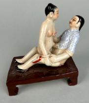 A CHINESE EROTIC CERAMIC GROUP DEPICTING MALE AND FEMALE FIGURES, 12cm x 10cm x 6cm