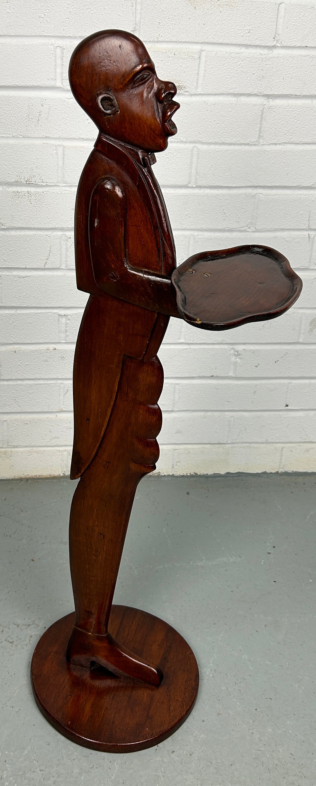 A MAHOGANY DUMBWAITER IN THE FORM OF A GENTLEMAN,