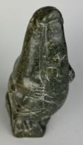 A CARVED INUIT SOAPSTONE FIGURE OF A SEAL WITH A FISH, 22cm H