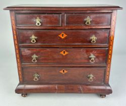 AN EARLY 19TH CENTURY APPRENTICE CHEST OF DRAWERS, With parquetry inlay raised on turned feet.