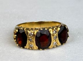 AN ANTIQUE 18CT GOLD RING SET WITH THREE GARNETS, Weight: 6.69 gms