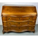 A CONTINENTAL WALNUT SERPENTINE BUREAU, 116cm x 108cm x 58cm Early 20th century, with fall front