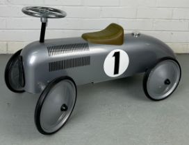 A TODDLER'S TOY MODEL OF A CLASSIC RACING CAR, With wheels, leather set and steering wheel. 75cm