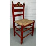 A RED SPANISH CHAIR WITH RUSH SEAT PAINTED WITH SCENE OF A MATADOR, 90cm x 40cm x 35cm