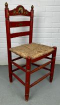 A RED SPANISH CHAIR WITH RUSH SEAT PAINTED WITH SCENE OF A MATADOR, 90cm x 40cm x 35cm