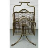 AN EARLY 20TH CENTURY REVOLVING BRASS MAGAZINE RACK WITH LION PAW FEET, 80cm x 40cm x 26cm