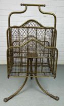 AN EARLY 20TH CENTURY REVOLVING BRASS MAGAZINE RACK WITH LION PAW FEET, 80cm x 40cm x 26cm