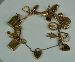 A 9CT GOLD CHARM BRACELET, Total weight: 43gms