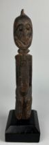 A DOGON STANDING FIGURE MOUNTED ON STAND 30cm x 5cm Mounted on a wooden stand.