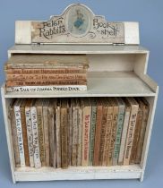 A COLLECTION OF 29 PETER RABBIT BOOKS WITH ORIGINAL PETER RABBITS BOOK CASE CIRCA 1940 29 books in