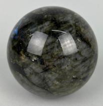 A LABRADORITE SPHERE WITH STRIKING FLASHES OF GREEN AND BLUE, 11cm in diameter
