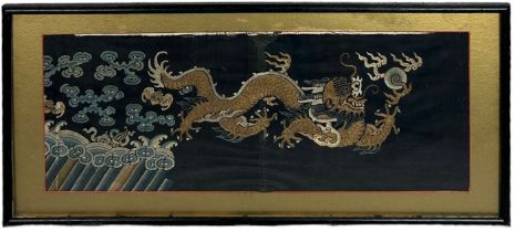 A 19TH CENTURY CHINESE EMBROIDERED SILK PANEL DEPICTING A FIVE CLAWED DRAGON CHASING THE FLAMING