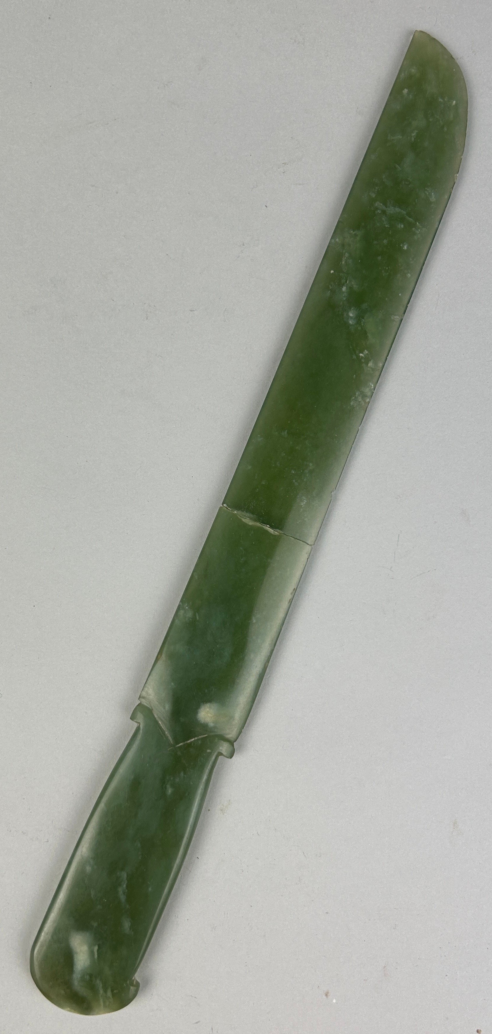 A CHINESE JADE RITUAL DAGGER BLADE (GE), Broken into two (clean break). 34cm L