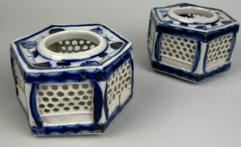A PAIR OF 20TH CENTURY BLUE AND WHITE PORCELAIN RETICULATED INCENSE BURNERS, 10cm x 5cm each. Some
