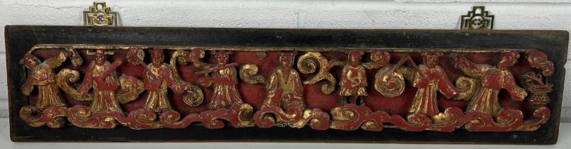 A Chinese red lacquer and gilt carved wood panel depicting figures 67cm x 14cm