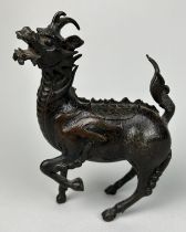 A CHINESE BRONZE FIGURE OF A MYTHICAL ANIMAL, POSSIBLY 18TH CENTURY, 18cm x 14cm With opening