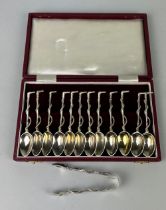 A SET OF LATE 19TH SILVER CENTURY TEASPOONS IN THE FORM OF RIDING CROPS ALONG WITH A PAIR OF TONGS