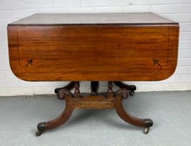AN EARLY 19TH CENTURY PEMBROKE TABLE WITH EBONY INLAY ON FOUR LEGS AND CASTORS, (some damage to
