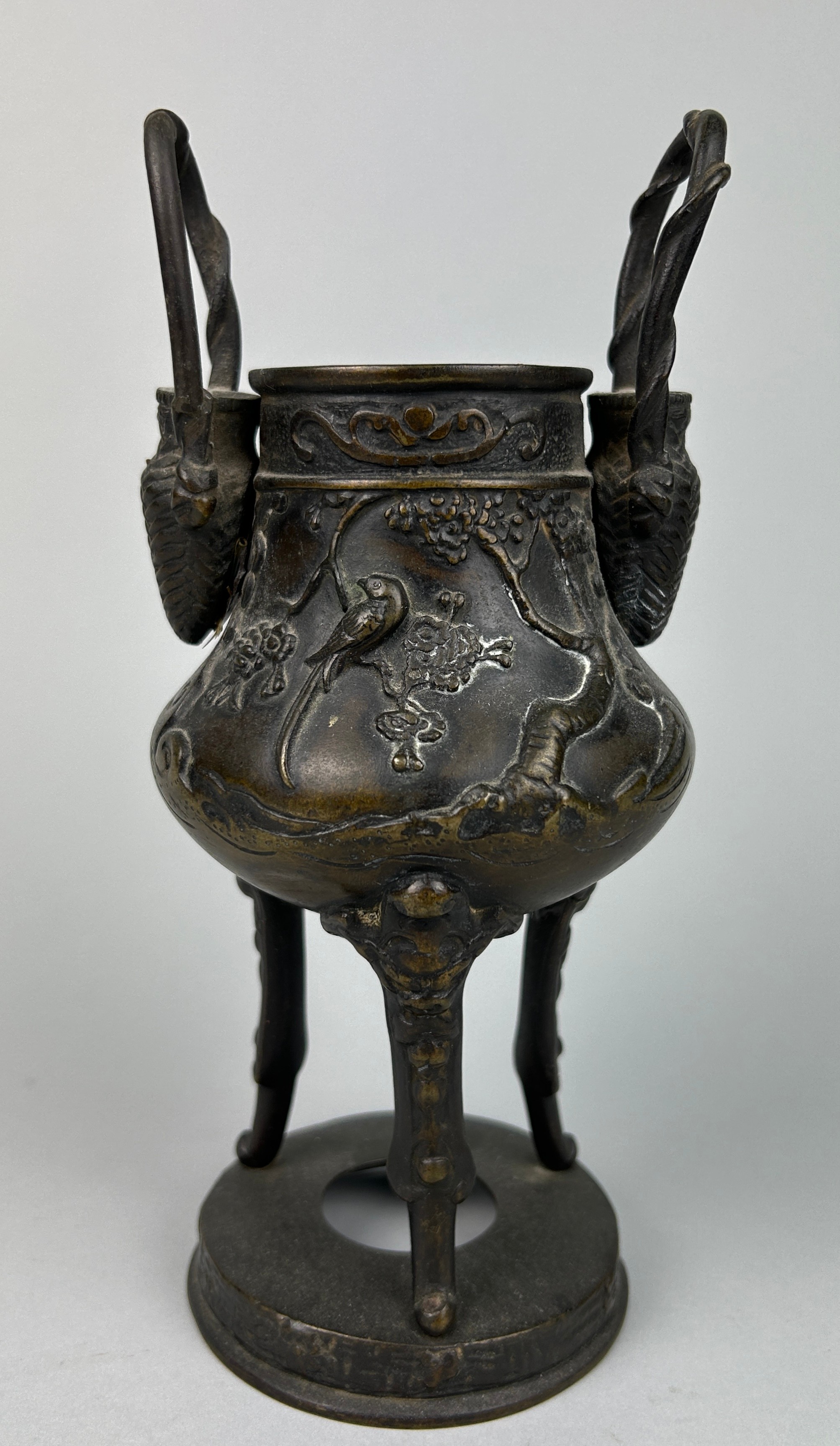 A LARGE JAPANESE BRONZE CENSER ON TRIPOD FEET AND STAND, Decorated with birds in trees with vase