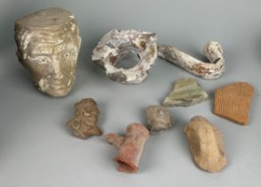 A COLLECTION OF ANCIENT COLLECTION OF POTTERY FRAGMENTS ALONG WITH A CARVED LIMESTONE BUST OF A MANS