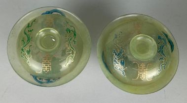 A PAIR OF JADE TEA CUPS AND COVERS, 10cm x 6cm each.
