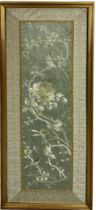 AN EARLY 19TH CENTURY CHINESE SILK PANEL DEPICTING FLOWERS AND BIRDS, 51cm x 14cm. In silk border,