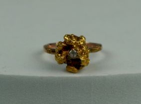 A 14CT GOLD RING SET WITH A LARGE GOLD NUGGET AND CLEAR STONE, Stone tests as not diamond. Weight: