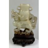 AN 18TH CENTURY CHINESE JADE WINGED DRAGON CARRYING AN ARCHAIC VASE, 7.5cm x 6.3cm x 2cm