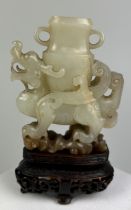 AN 18TH CENTURY CHINESE JADE WINGED DRAGON CARRYING AN ARCHAIC VASE, 7.5cm x 6.3cm x 2cm