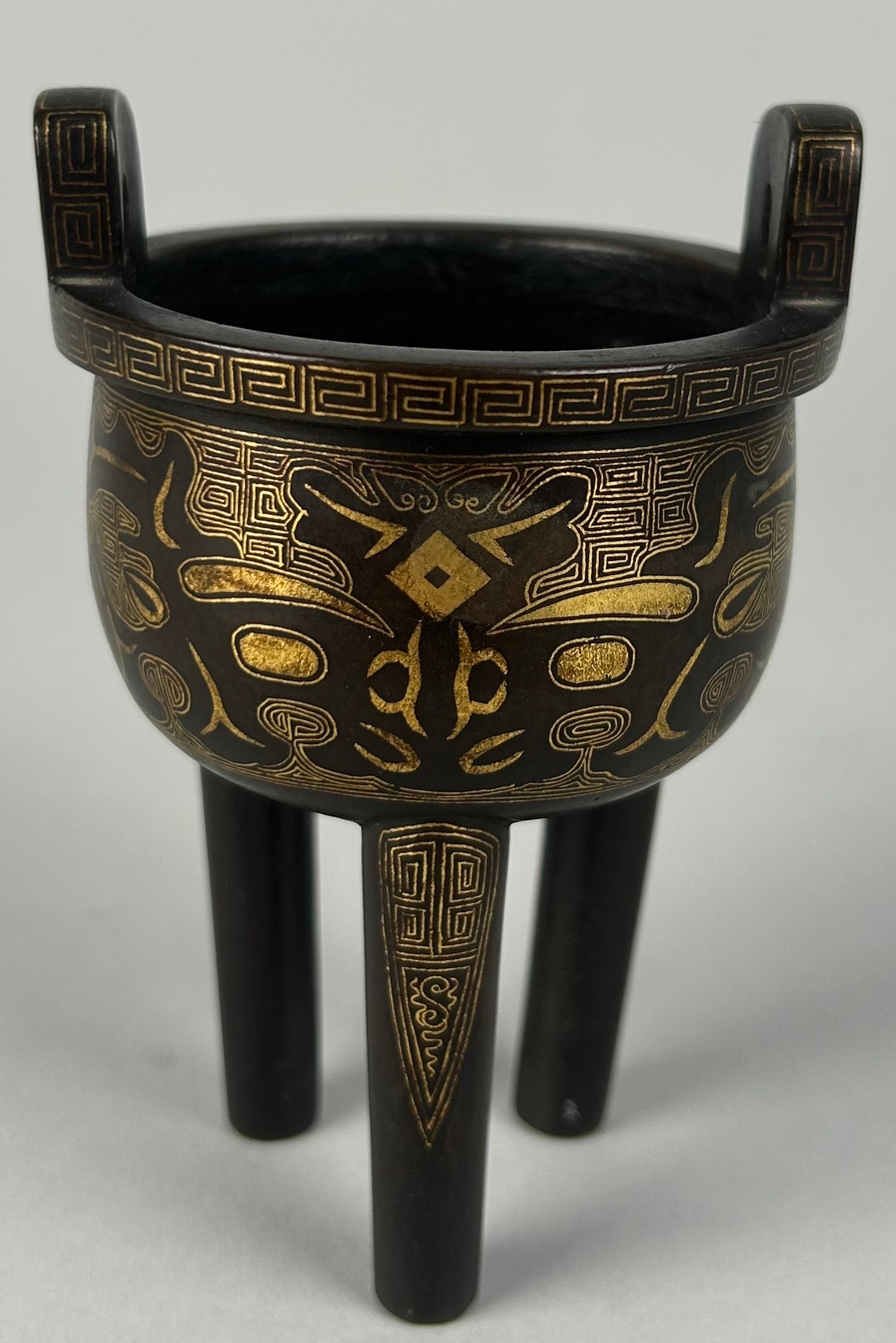 A CHINESE BRONZE RITUAL VESSEL (DING) DECORATED WITH GOLD LEAF,