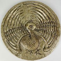IN THE MANNER OF MARTIN BROTHERS: A LARGE PLAQUE DEPICTING A BIRD WITH FANNED WINGS, 32cm D Old