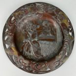 A 19TH CENTURY JAPANESE PLATE DECORATED WITH A FIGURE PLAYING THE PIPE AND A LADY PLAYING A STRINGED