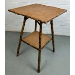 A TIGER BAMBOO OCCASIONAL TABLE WITH TWO TIERS,