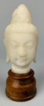 A CHINESE MARBLE HEAD OF A GUANYIN ON STAND, 11cm x 7cm