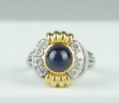 AN 18CT GOLD RING SET WITH A SAPPHIRE AND EIGHT DIAMONDS 8.9gms