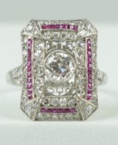 A RING SET WITH CENTRAL DIAMOND SURROUNDED BY RUBIES AND DIAMONDS,