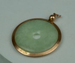 A CHINESE JADE BI SET IN 9CT GOLD, In Goldsmiths and Silversmiths Company case. Weight: 8.55gms 3.