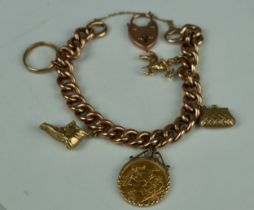A 1911 HALF SOVEREIGN ON A 9CT GOLD BRACELET WITH VARIOUS CHARMS Weight: 37gms