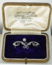 A BELLE EPOCH OR 1920'S PLATINUM BROOCH SET WITH A CENTRAL DIAMOND, FIVE SAPPHIRES AND SMALLER