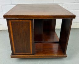 A LOW MAHOGANY REVOLVING BOOKCASE WITH PARQUETRY INLAID BORDER (some damage)