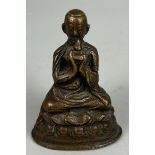 A 19TH CENTURY BRONZE FIGURE OF A SEATED MONK, 7cm x 5cm