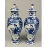 A PAIR OF 19TH CENTURY CHINESE BLUE AND WHITE PORCEALIN VASES WITH LIDS, Decorated with figures