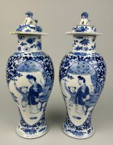 A PAIR OF 19TH CENTURY CHINESE BLUE AND WHITE PORCEALIN VASES WITH LIDS, Decorated with figures