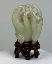 A 19TH CENTURY CHINESE WHITE JADE CARVING OF A BUDDHA’S HAND CITRON, 5cm x 3.8cm