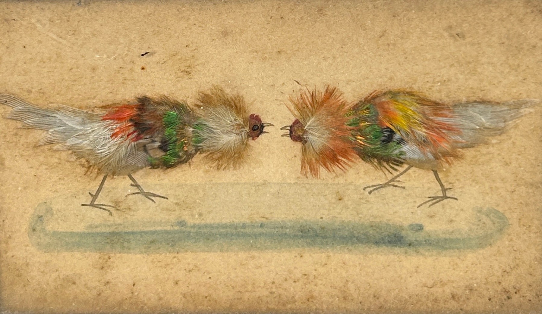 COCKFIGHTING INTEREST: A FRAMED SET OF THREE WATERCOLOURS WITH APPLIED BIRD FEATHERS DEPICTING A - Image 2 of 4