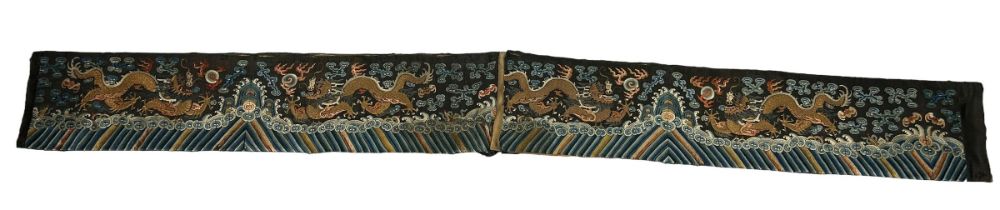 A LARGE 19TH CENTURY CHINESE SILK BANNER DECORATED WITH A FIVE CLAW DRAGON CHASING THE FLAMING