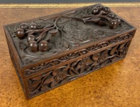 A 19TH CENTURY BLACK FOREST STYLE CARVED BOX DECORATED WITH FLORA AND FAUNA 28cm x 14cm x 10cm