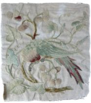 AN EMBROIDERY TEXTILE DEPICTING A PARROT ON A BRANCH, Possibly 19th Century. 31cm x 29cm