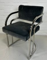 A FIRE DAMAGED DESIGNER CHROME AND VELVET UPHOLSTERED CHAIR FROM THE FILM SET OF LUTHER, 80cm x 52cm